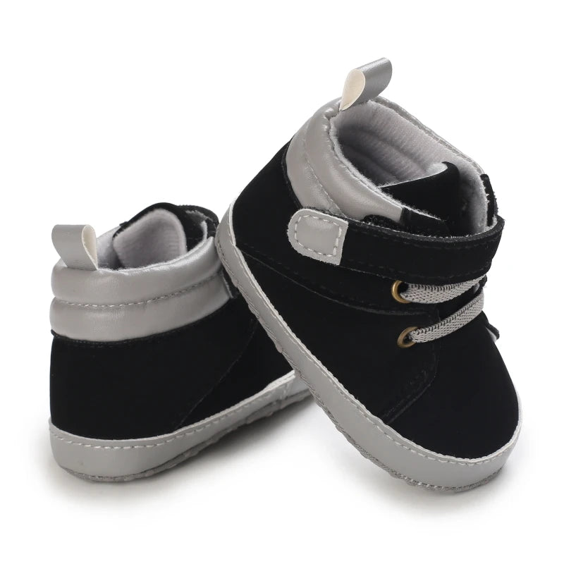 Pair of black and gray baby shoes on a white background