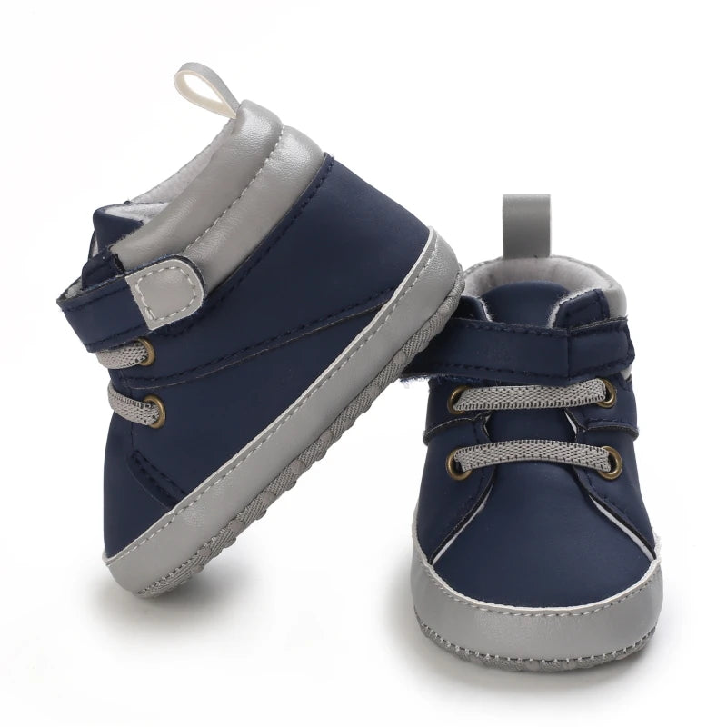 Pair of navy and gray baby shoes on a white background