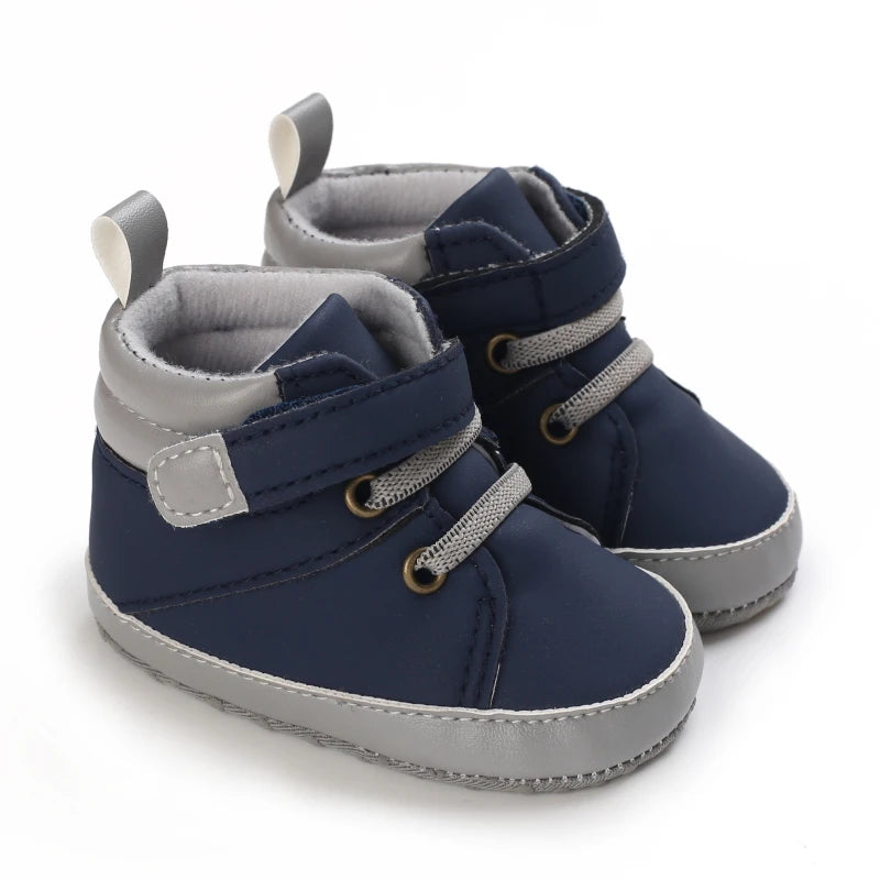 Pair of navy blue and gray baby boots on a white background