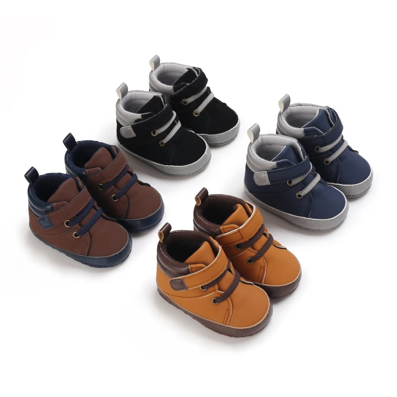 Set of children's boots in brown, black, and blue on a white background