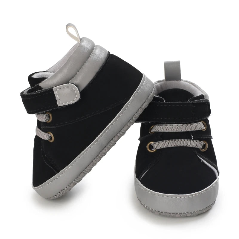 Black and gray baby shoes on a white background
