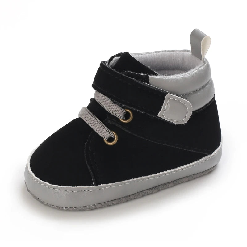 Black and gray baby shoe with a strap on a white background