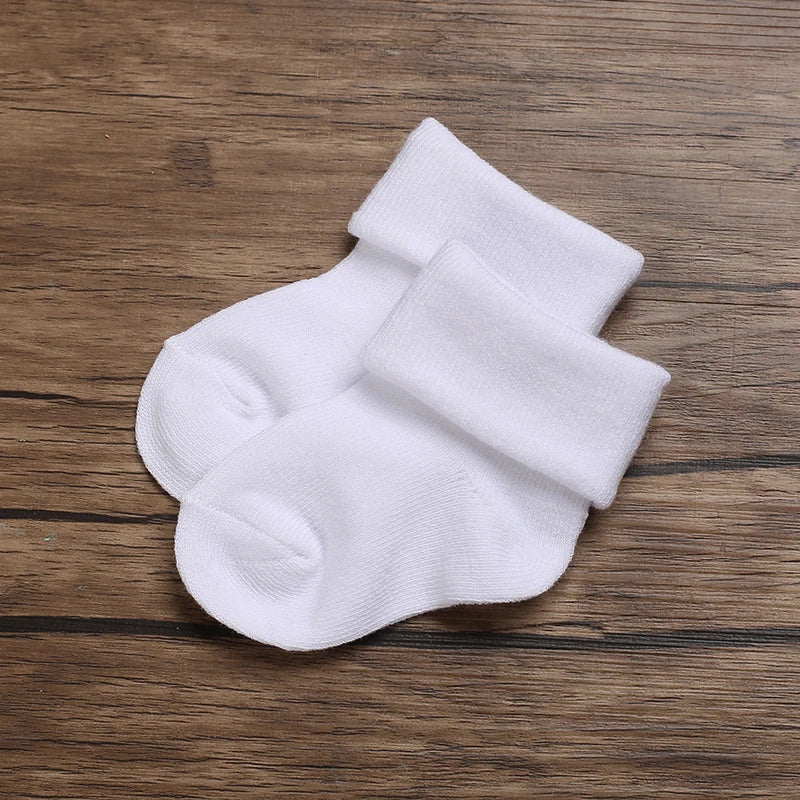 Pair of white socks on a wooden surface