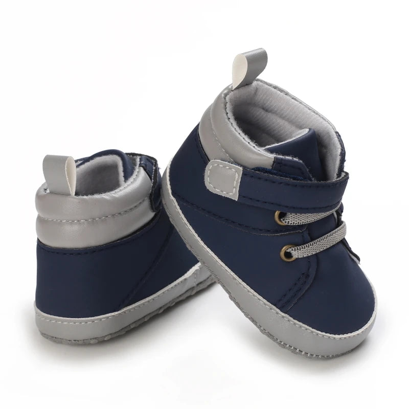Pair of navy and gray baby boots on a white background