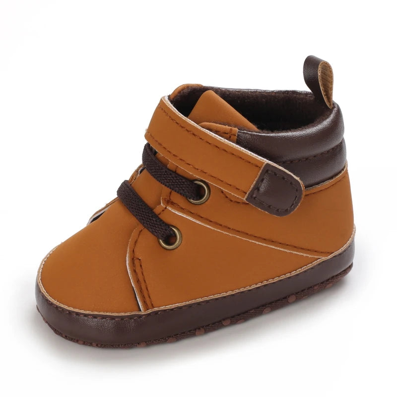 Brown baby shoe with a strap on a white background