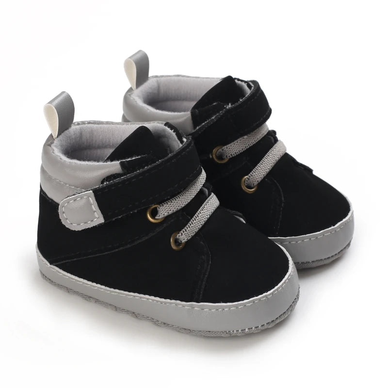 Black and gray baby shoes on a white background