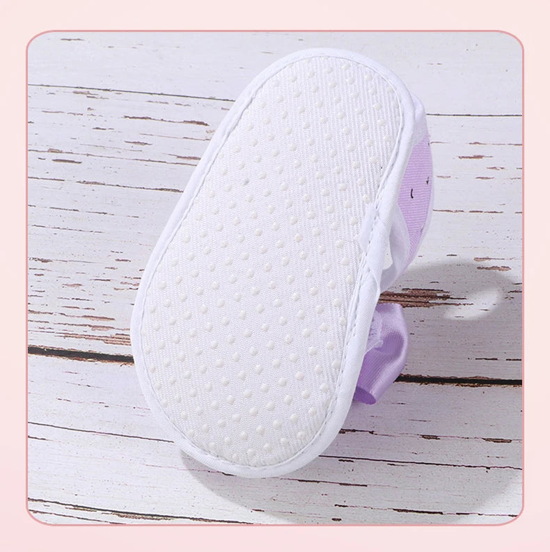 White shoe sole with purple heel on a wooden surface