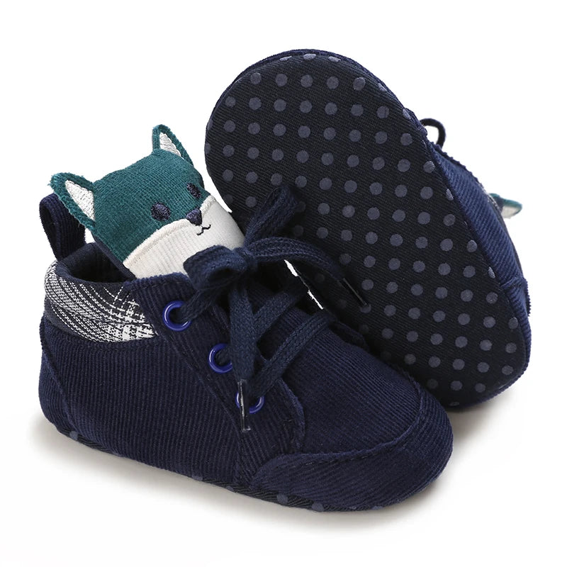 Navy blue baby shoes with a soft animal face design on a white background