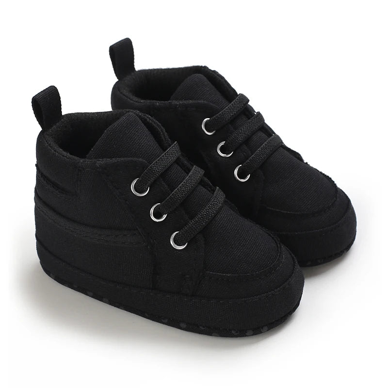 Black baby shoes with soft sole on a white background