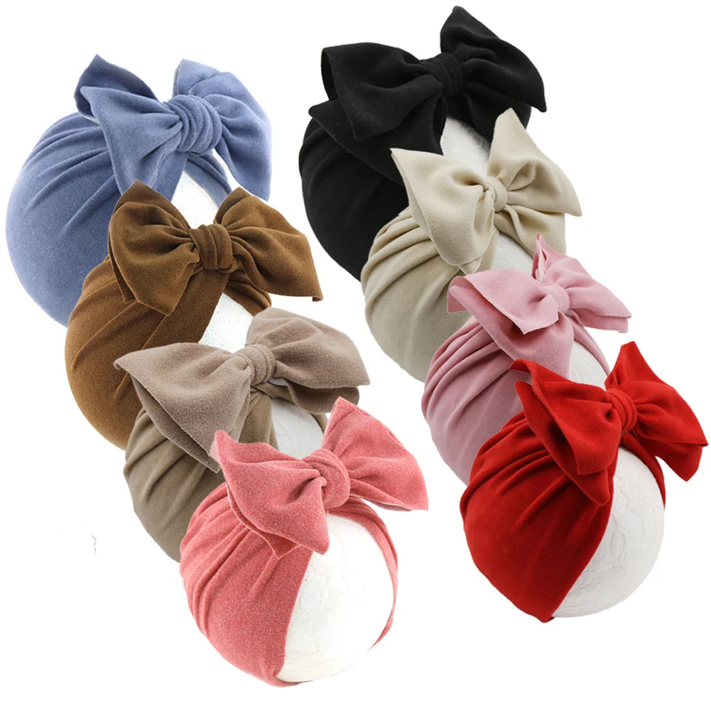 Set of colorful headbands with large bows in various colors on a white background