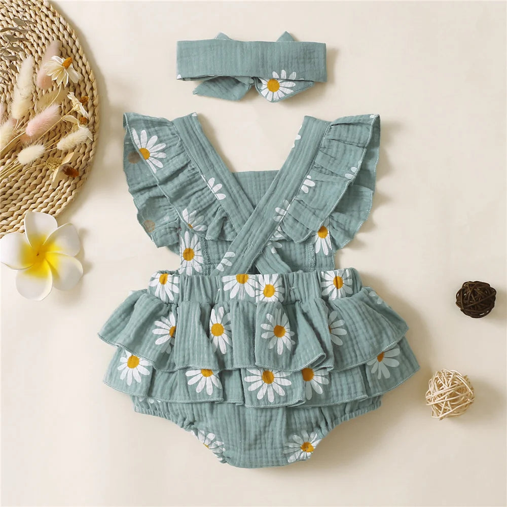 Green baby romper with floral pattern on a beige background
