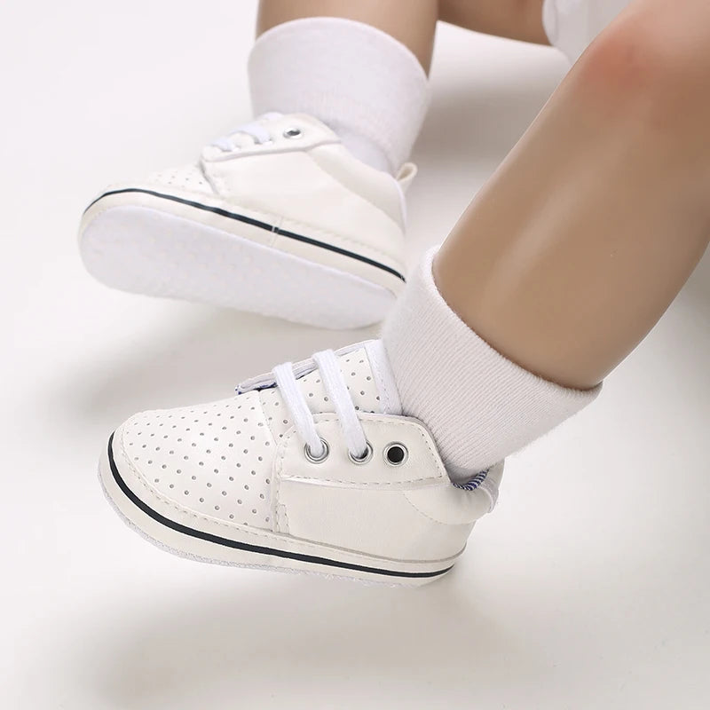 White sneakers worn with white socks on a light background