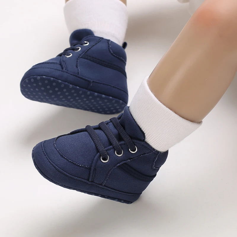 Navy blue baby shoes with white socks on a light background