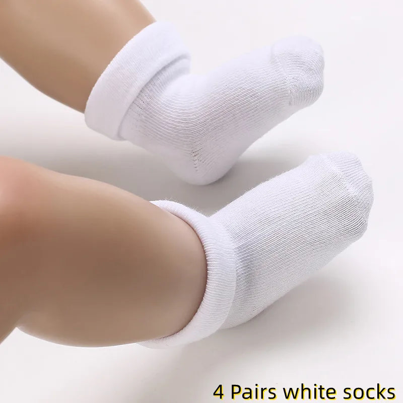 White socks being worn on a person's feet with text indicating '4 Pairs white socks'.