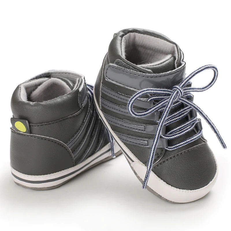 Pair of gray high-top sneakers with blue laces on a white background