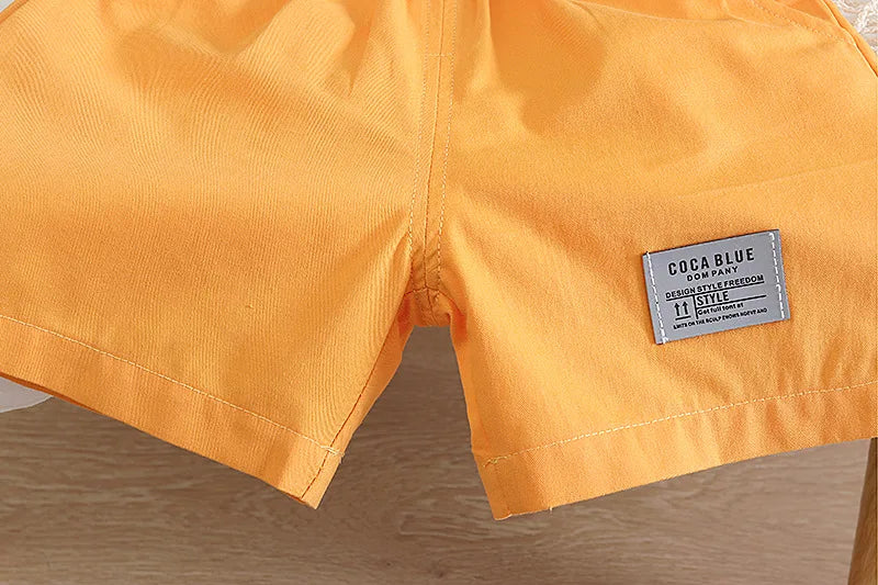 Close-up of orange shorts with a visible label on a wooden surface
