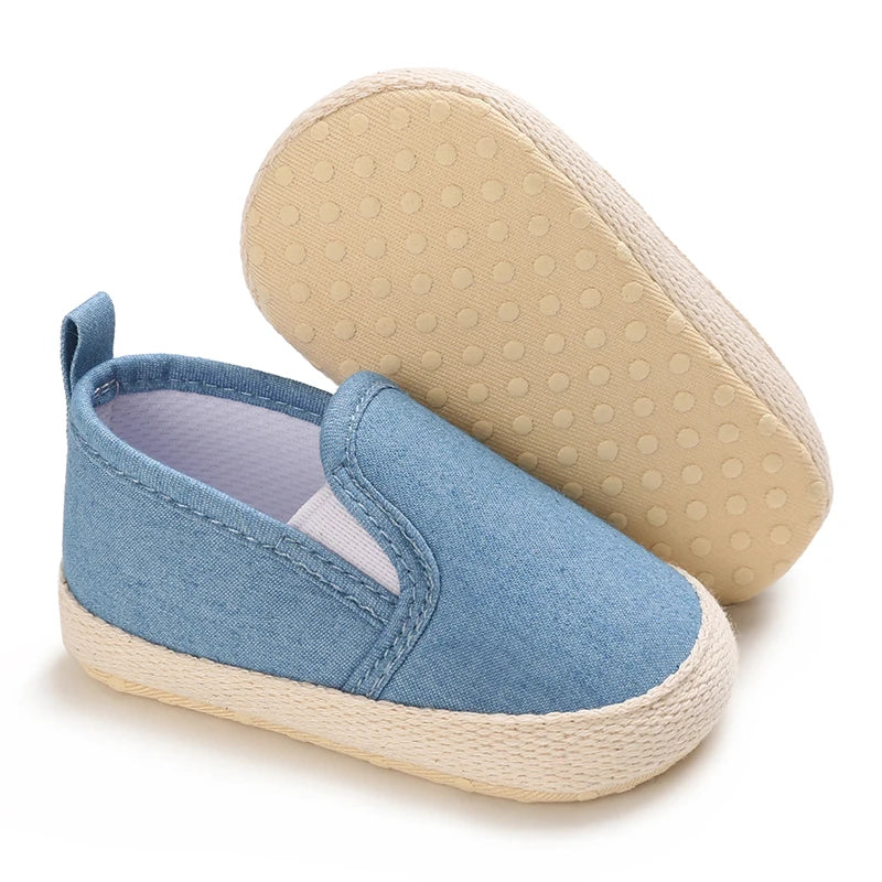 Blue baby shoe with beige sole on a white background