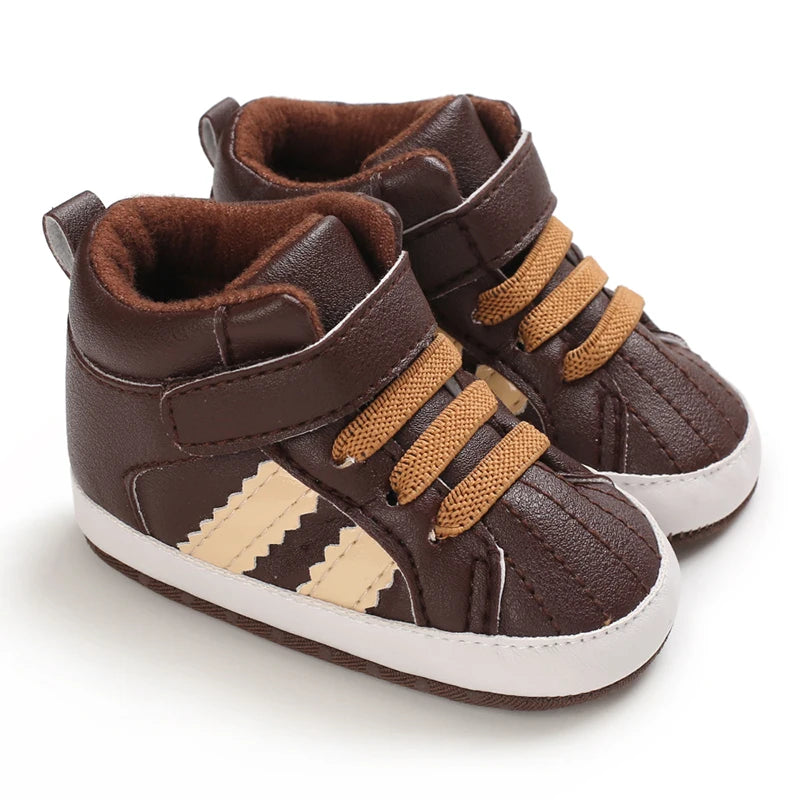 Pair of brown children's sneakers with white soles on a white background