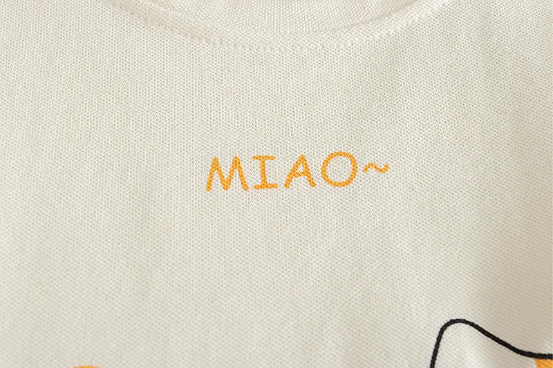 Text 'MIAO~' embroidered on a light-colored fabric with a cat design.
