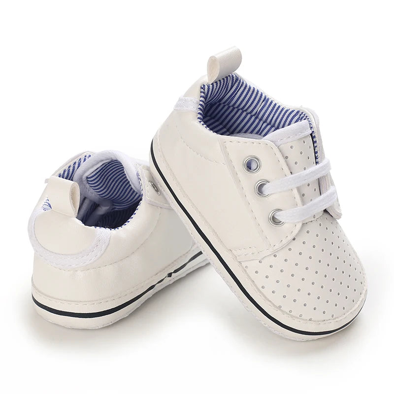 Pair of white baby shoes with blue interior on a white background
