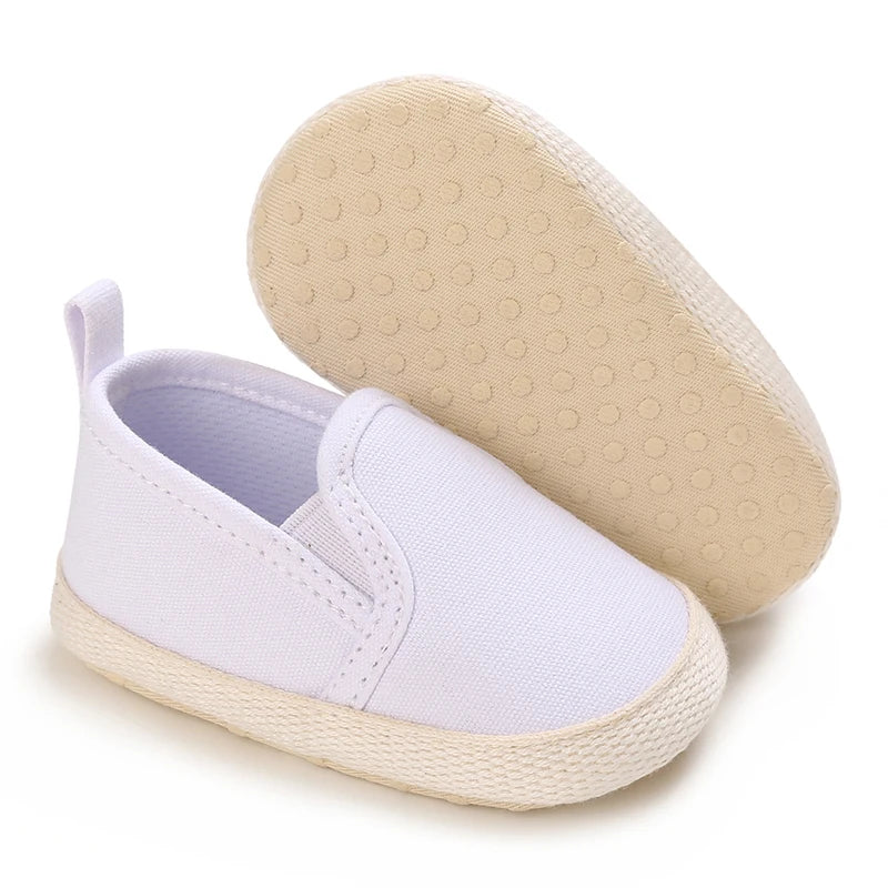 White baby shoe with beige sole on a white background