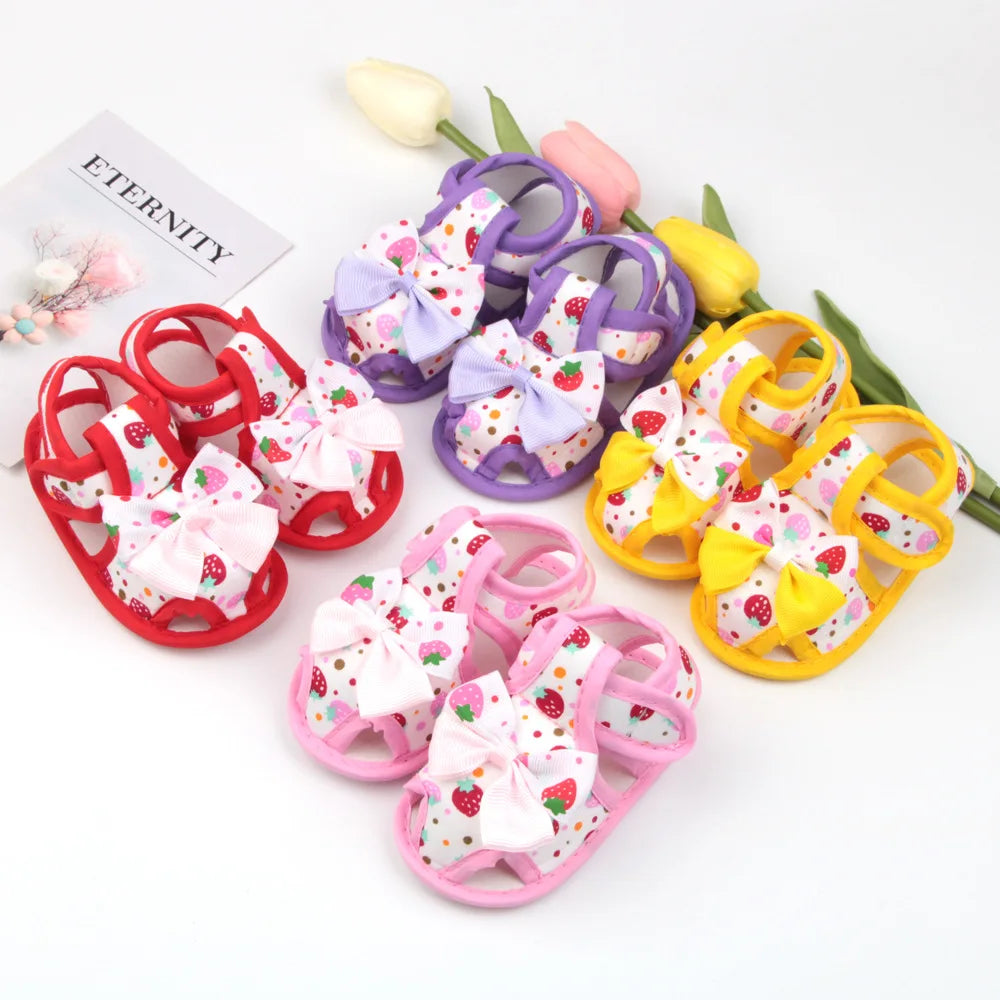 Colorful children's sandals with floral designs on a white background