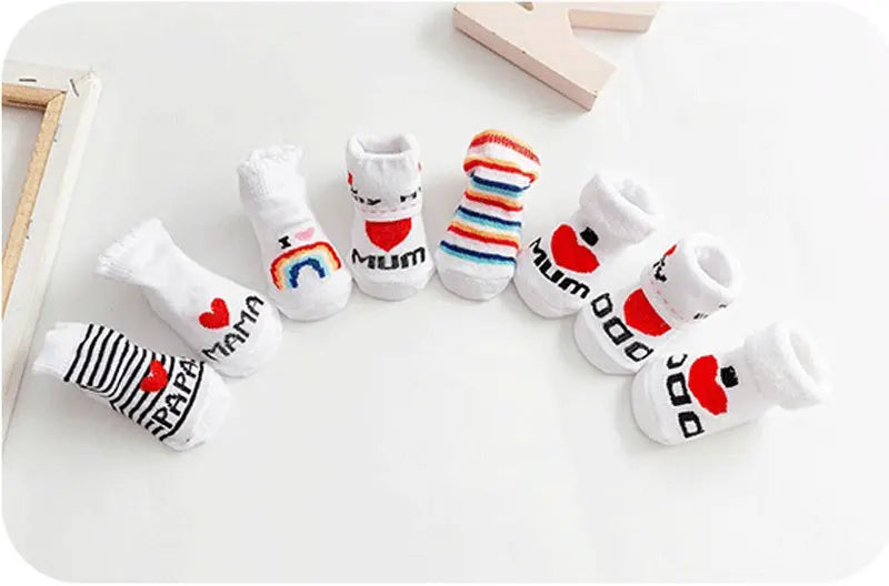 Set of baby socks with 'I love mum' and 'I love dad' text on a white background