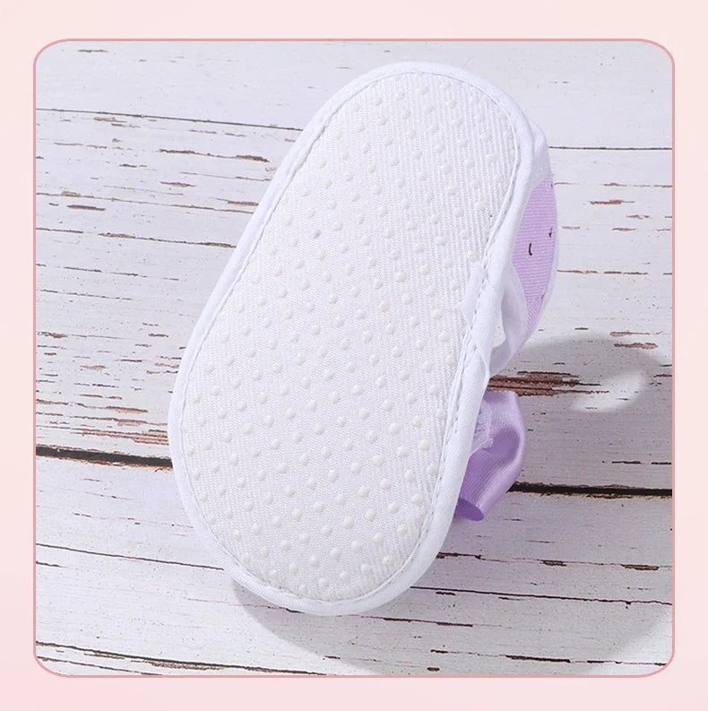 White shoe sole with purple heel on a wooden surface