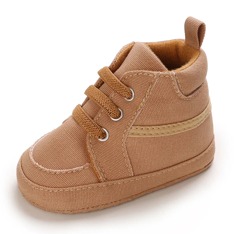 Brown baby shoe with a strap on a white background