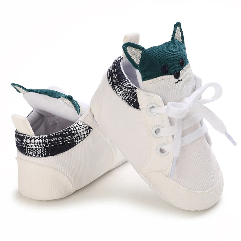 White baby sneakers with fox design on a white background