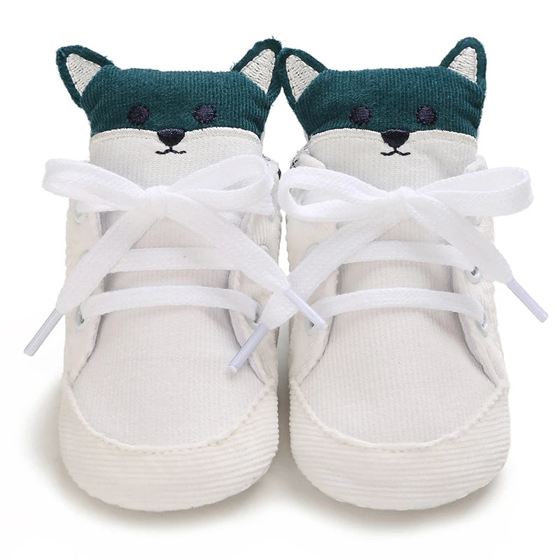 Pair of baby shoes with fox face design on a white background