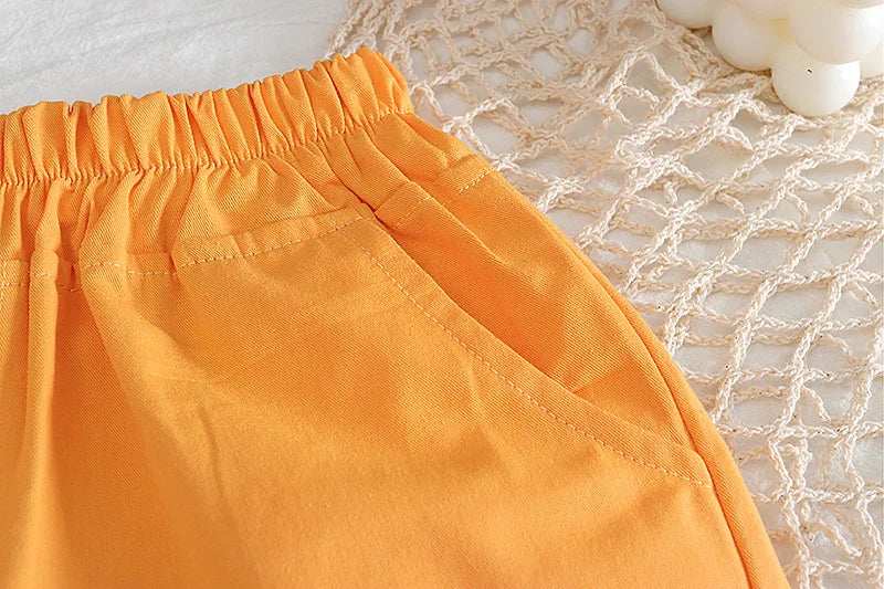 Close-up of orange shorts on a textured surface