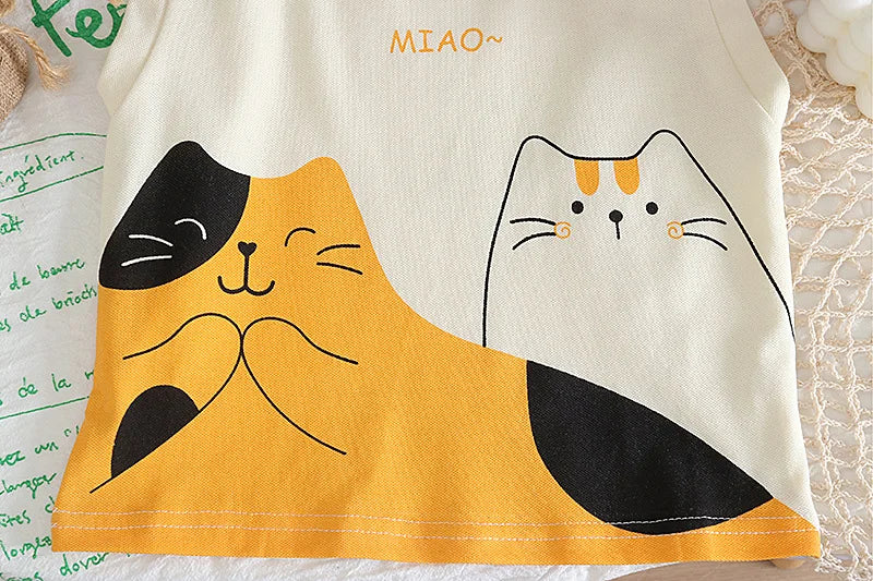 Children's tank top with cartoon cat design on a textured surface