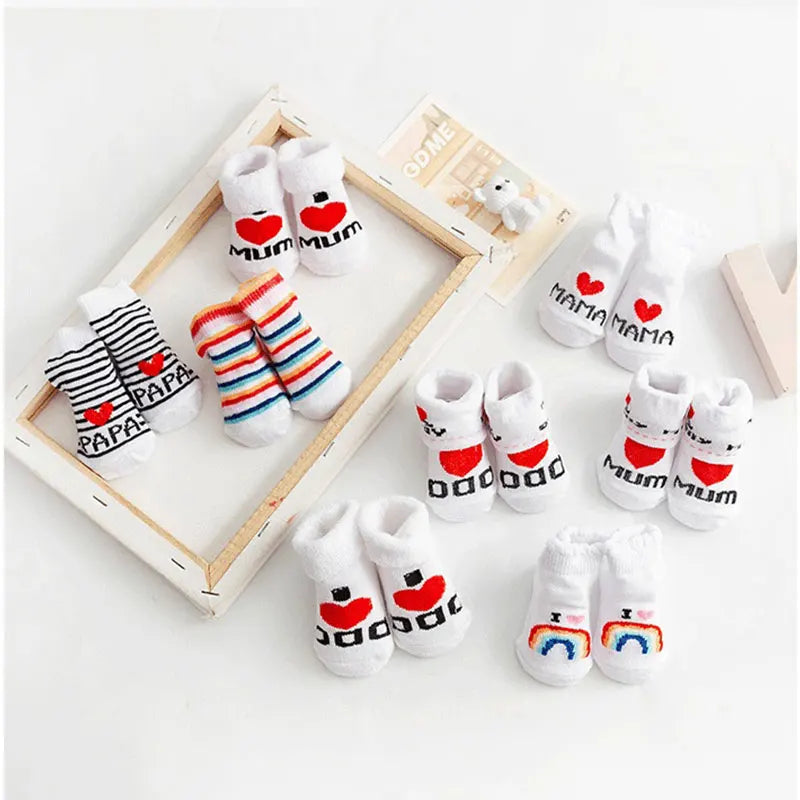 Set of baby socks with heart designs and text on a white background