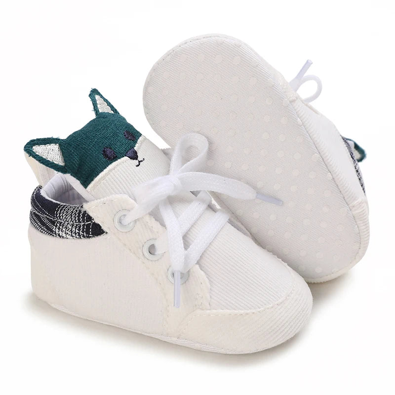 White baby sneakers with fox design on a white background