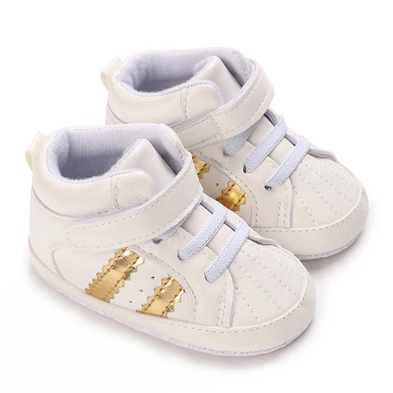 White high-top sneakers with gold accents on a white background