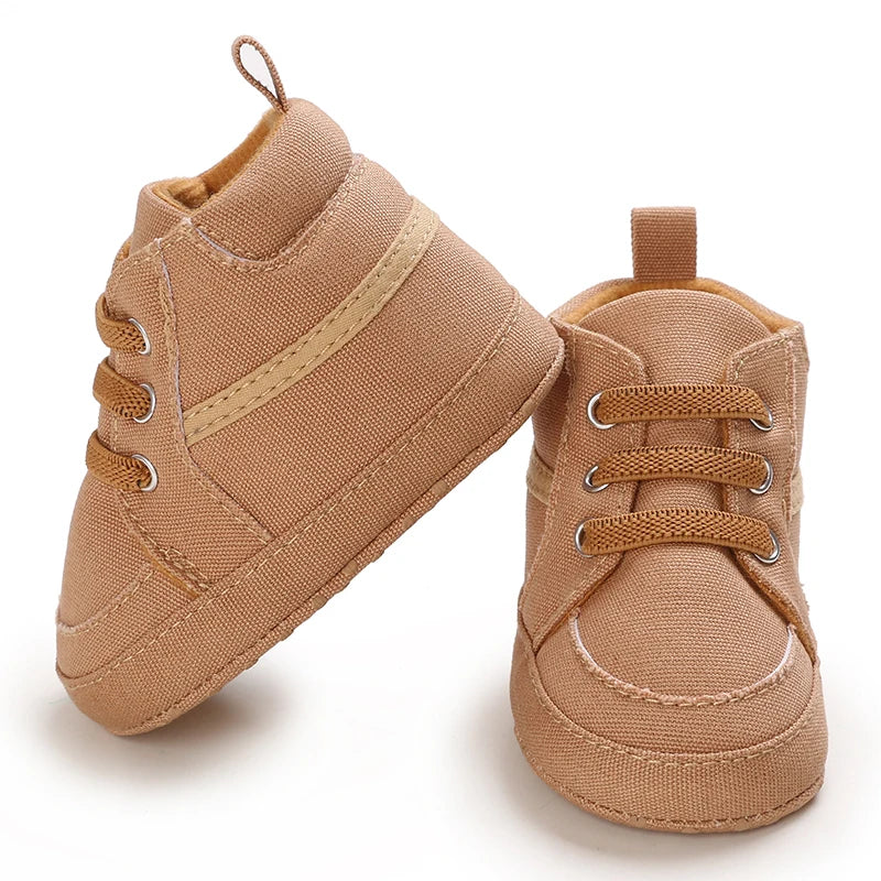 Pair of brown baby shoes on a white background