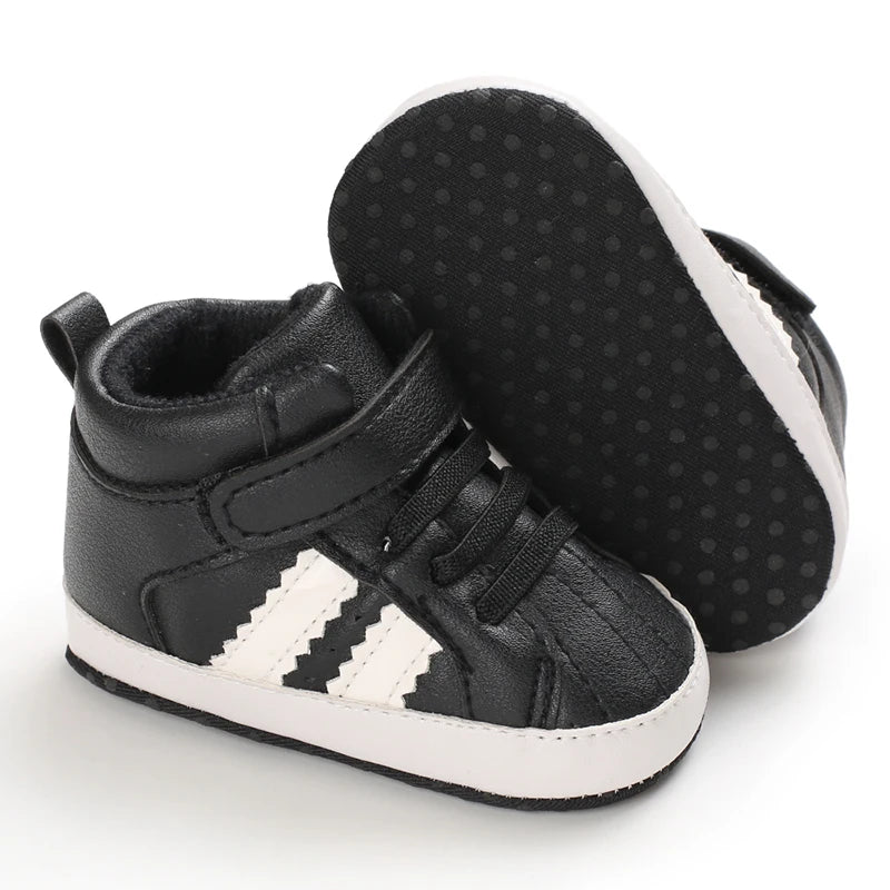 Black high-top sneakers with white stripes on a white background