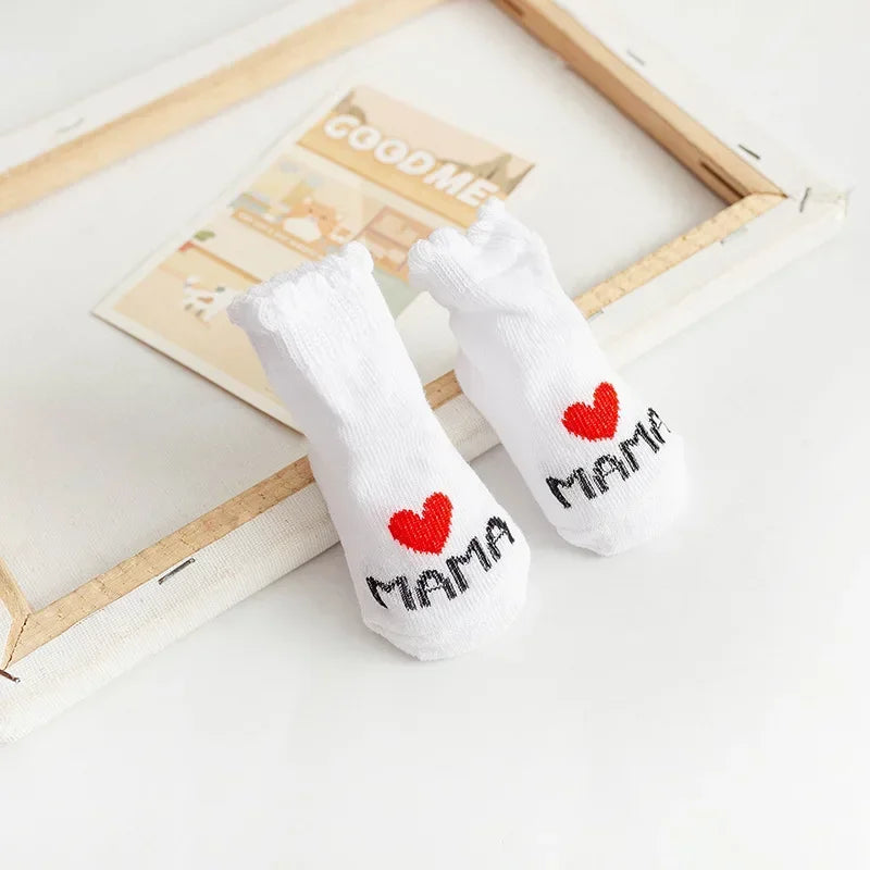 White socks with red hearts and 'MAMA' text on a light background