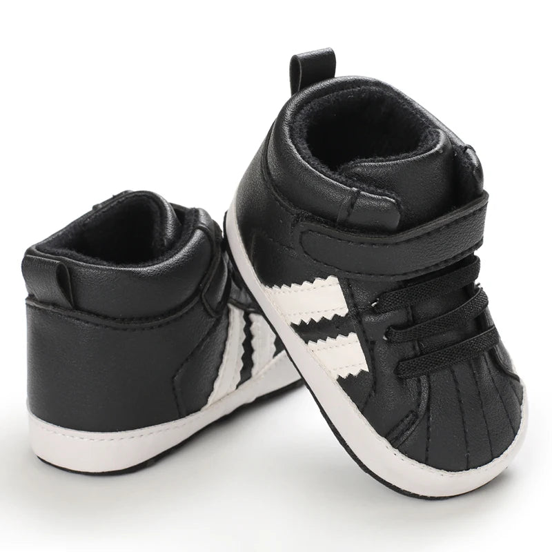 Black high-top sneakers with white stripes on a white background