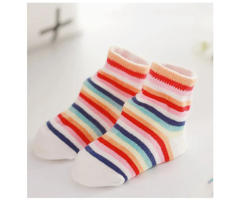 Pair of colorful striped socks on a light background