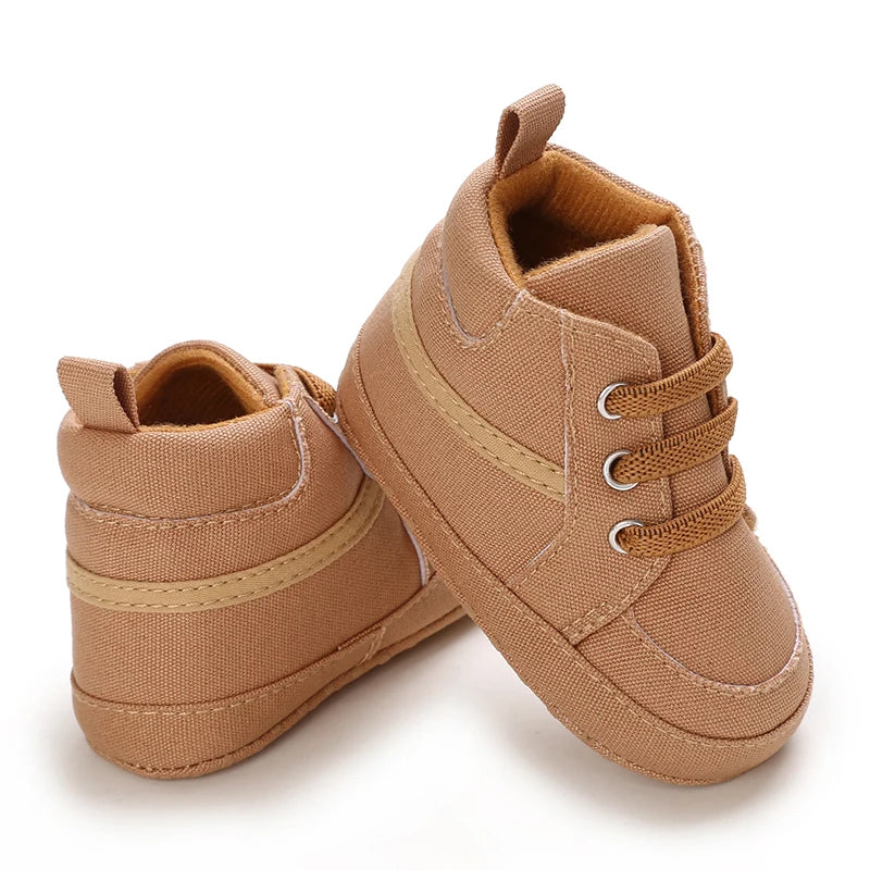 Pair of brown baby shoes on a white background