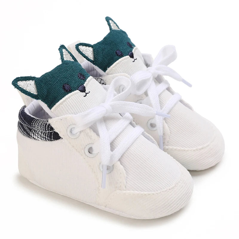 White baby sneakers with fox design on a white background