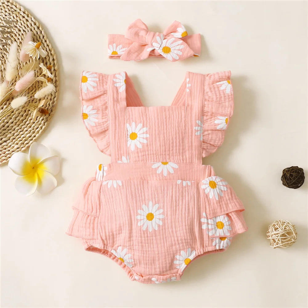 Pink floral baby romper with matching headband on a light background
