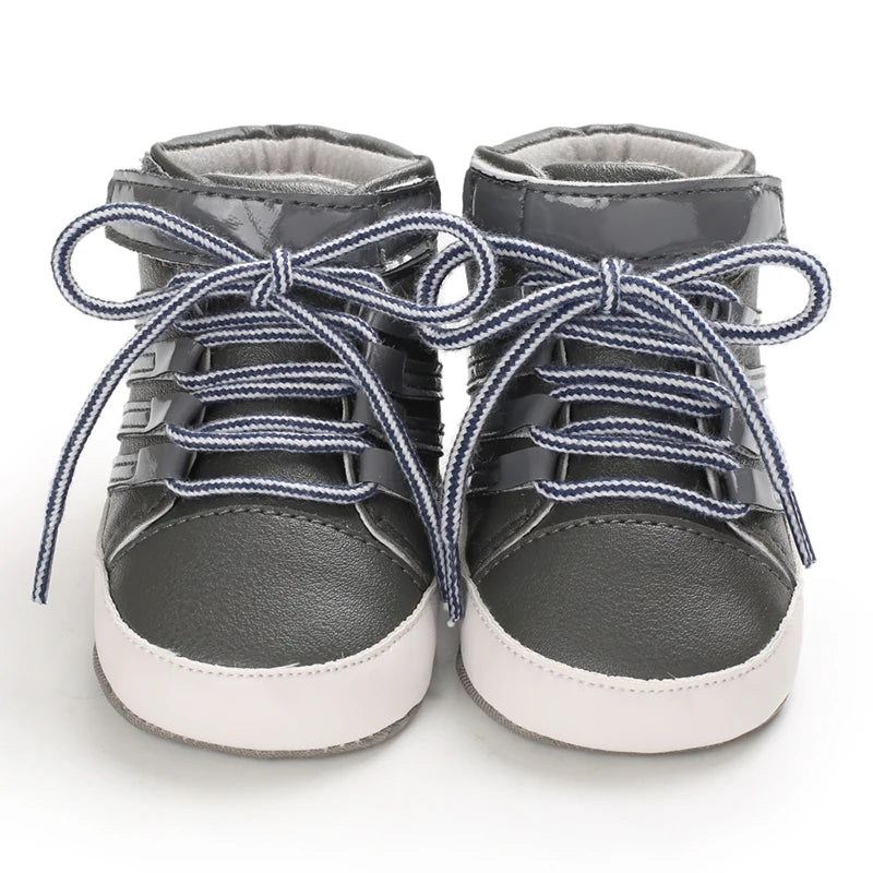 Pair of gray high-top sneakers with blue laces on a white background