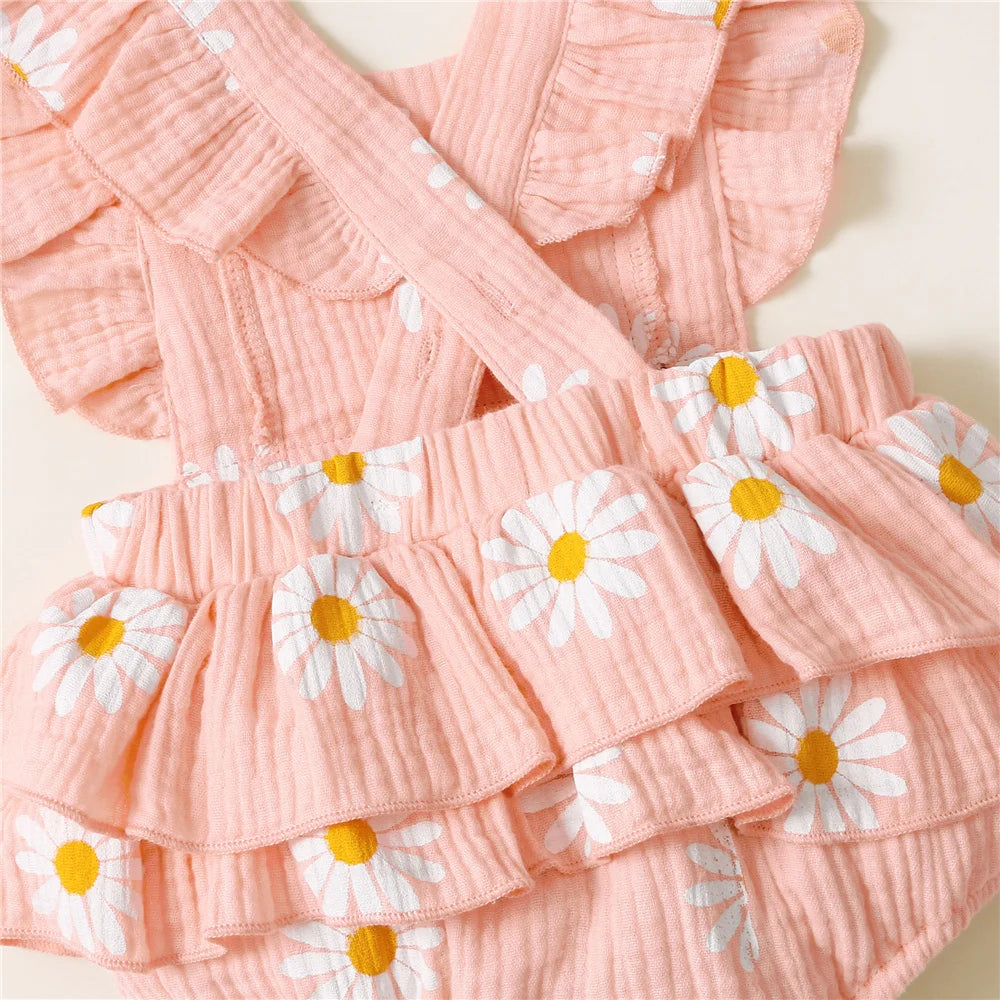 Pink textured fabric with white daisy patterns on a light background
