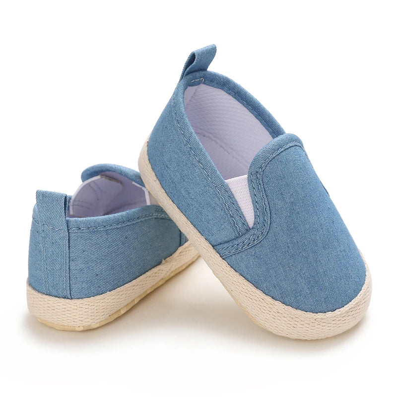 Pair of blue children's shoes with white soles on a white background