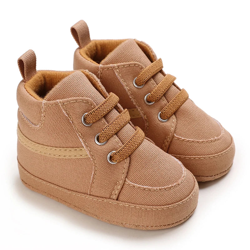 Pair of brown baby shoes on a white background