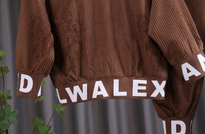 Brown corduroy jacket with 'DWALEX' branding on a gray background