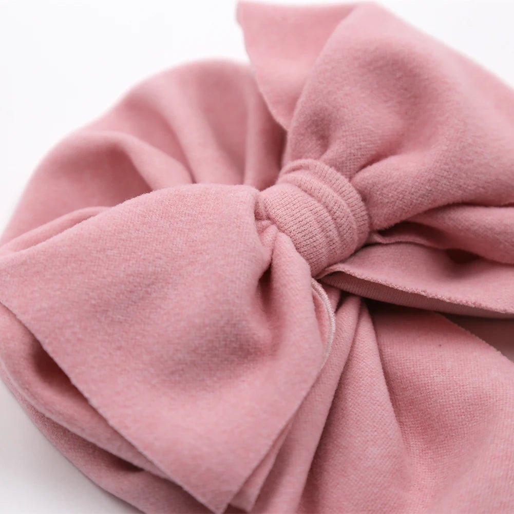 Close-up of a pink knotted headband on a white background